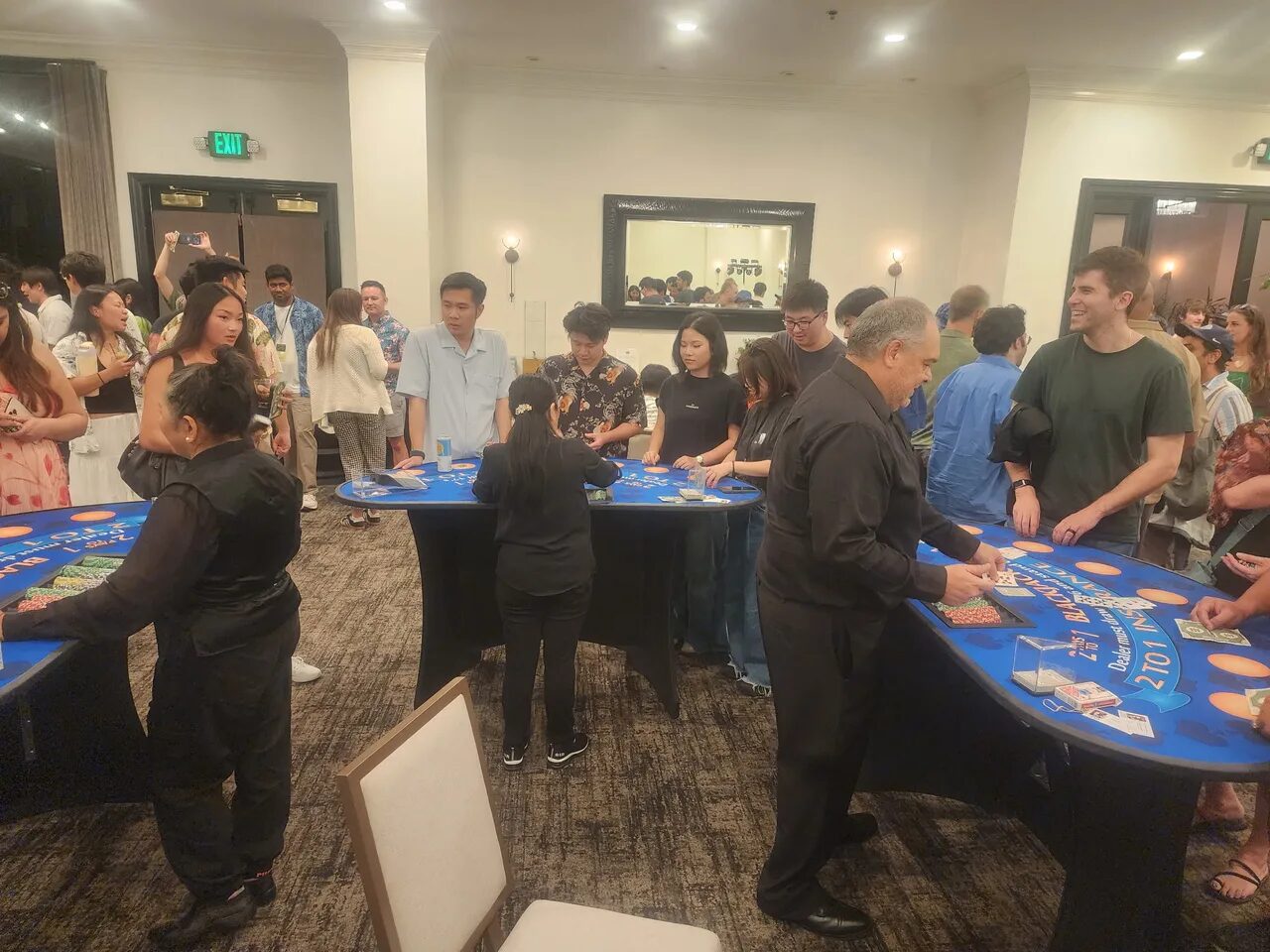 Birthday party crowd around a blackjack table at a Bay Area casino night
